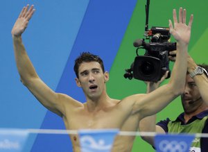 United States Michael Phelps acknowledges the crowd after his team won gold in the men's 4 x 100-meter medley relay final during the swimming competitions at the 2016 Summer Olympics, Saturday, Aug. 13, 2016, in Rio de Janeiro, Brazil.