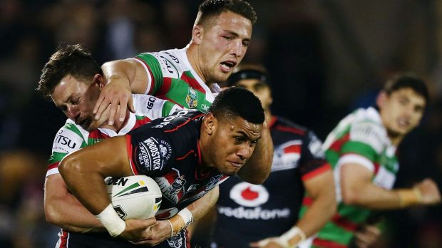 Hard yards: David Fusitu'a of the Warriors is tackled by Damien Cook and Sam Burgess.