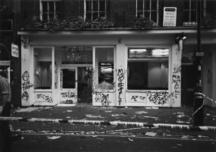 [ Photo: Smashed up McDonalds restaurant covered in graffiti ]