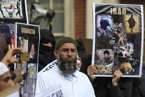 File - Anjem Choudary, centre, one of the founders of the group 'Muslims against Crusades' leads members as they gather for an anti-U.S. rally, held close to the memorial ceremony to mark the 10th anniversary of the September 11 attacks at the Memorial Garden, adjacent to the U.S Embassy in central London, Sunday Sept. 11, 2011.