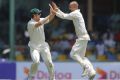 Mistimed sweep: Nathan Lyon celebrates the wicket of Angelo Mathews off an ill-judged shot with Mitchell Marsh.