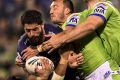 Close encounter: Storm prop Jesse Bromwich is tackled by Raiders hooker Josh Hodgson.