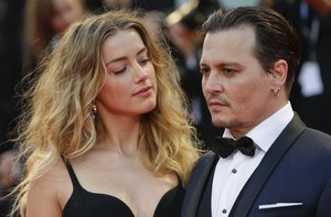 File - Amber Heard, left, and Johnny Depp pose for photographers upon arrival at the premiere of the film Black Mass during the 72nd edition of the Venice Film Festival in Venice, Italy, Friday, Sept. 4, 2015.