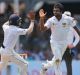 Dilruwan Perera, right, and Kusal Mendis celebrate the dismissal of David Warner.