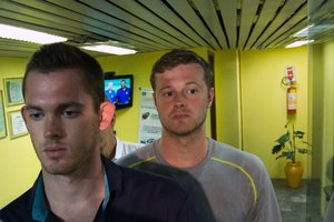 American Olympic swimmers Gunnar Bentz, left, and Jack Conger, center, leave the police station at Rio International airport early Thursday Aug. 18, 2016