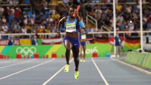 United States' Morolake Akinosun crosses the line to finish a women's 4x100-meter relay rerun after dropping the baton ...