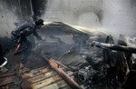 A soldier uncovers the body of a man under the rubble of a food factory hit by Saudi-led airstrikes in Sanaa, Yemen, Tuesday, Aug. 9, 2016.