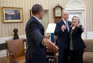 File - "This is one of those rare instances where my presence indirectly became a part of this reaction from those pictured in the photograph. Secretary of State Hillary Clinton had just accidentally dropped all of her briefing papers onto the Oval Office rug and she, President Obama and Vice President Biden all reacted in a way that indicated that surely I wouldn't get a photo of that to embarrass her."