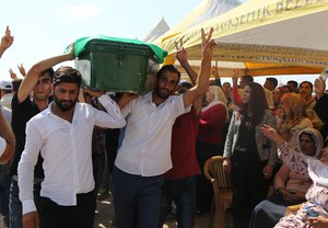 People mourn as they attend funeral services for dozens of people killed in last night’s bomb attack targeting an outdoor wedding party in Gaziantep, southeastern Turkey, Sunday, Aug. 21, 2016.