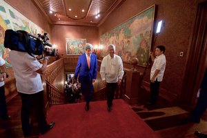 File - Philippines Foreign Secretary Perfecto Yasay guides U.S. Secretary of State John Kerry as they walk through the Malacañang Palace in Manila, Philippines, on July 27, 2016, before the Secretary held a working lunch with Philippines President Rodrigo Duterte.