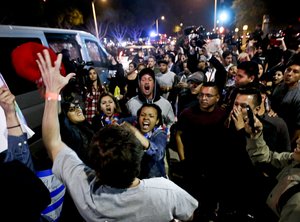 In this April 28, 2016 file photo, a Trump supporter clashes with protesters outside a rally for Republican presidential candidate Donald Trump in Costa Mesa, Calif.