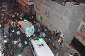 People carry dead bodies at the ambulances after an explosion in Gaziantep, southeastern Turkey, early Sunday, Aug. 21, 2016.