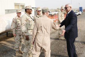 File - Former Secretary of State Colin Powell visits soldiers at Camp Lemonnier in Djibouti on July 8, 2011.