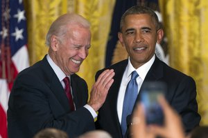 Vice President Joe Biden, left, and President Barack Obama react after a heckler was removed from the East Room of the White House during a reception to celebrate LGBT Pride Month, on Wednesday, June 24, 2015, in Washington.