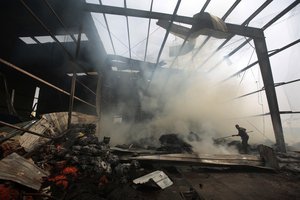 A worker looks for survivors amid the rubble of a food factory that was hit by Saudi-led airstrikes, in Sanaa, Yemen, Tuesday, Aug. 9, 2016.