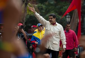 Venezuela’s President Nicolas Maduro greets supporters upon his arrival to Bolivar Square to celebrate the 206th anniversary of the call for independence from Spain, in Caracas, Venezuela, Tuesday, April 19, 2016.