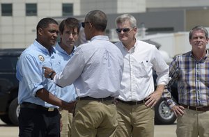 President Barack Obama talks with greeters after arriving on Air Force One at Baton Rouge Metropolitan Airport in Baton Rouge, La., Tuesday, Aug. 23, 2016.