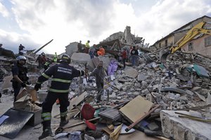 Rescuers search for survivors through the rubble of collapsed buildings following an earthquake, in Amatrice, Italy, Wednesday, Aug. 24, 2016.