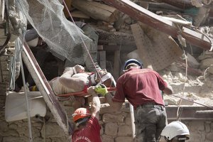 An injured man is rescued from a collapsed building following an earthquake in Amatrice, central Italy, Wednesday, Aug. 24, 2016. The magnitude 6 quake struck at 3:36 a.m.