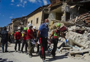 A victim is taken away in Amatrice, central Italy, where a 6.1 earthquake struck just after 3:30 a.m., Wednesday, Aug. 24, 2016.