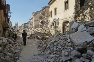 A man walks in a street in Amatrice, central Italy, where a 6.1 earthquake struck just after 3:30 a.m., Wednesday, Aug. 24, 2016.