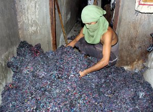 A Labourer working at a black cotton processing plant in Jammu, India, 24 August 2016.