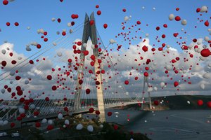 Red and white balloons, symbolising the colours of Turkish national flag, float in the air during the inauguration of the new Yavuz Sultan Selim Bridge, the third bridge over the Bosporus, in Istanbul