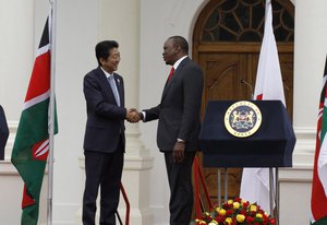 Japan's Prime Minister Shinzo Abe, left, and Kenyan President Uhuru Kenyatta shake hands after giving a joint press conference at State House in Nairobi, Kenya