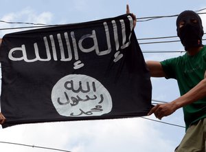 A man holding Islamic State Militant's flag