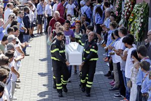 The coffin of 9-year-old Giulia Rinaldo,  is carried outside the gymnasium at the end of the state funeral service in Ascoli Piceno, Italy, Saturday, Aug. 27, 2016