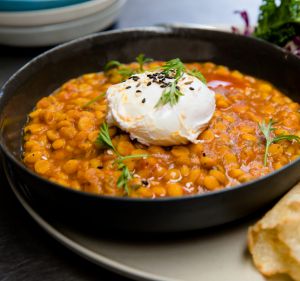 The chana dal brekkie bowl with coconut roti, slaw and poached egg at Two Chaps.