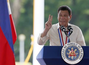 Philippine President Rodrigo Duterte gestures as he addresses the guests during wreath-laying ceremony at the Tomb-of-the-Unknown-Soldier in observance of National Heroes Day Monday, Aug. 29, 2016 at the Heroes Cemetery in suburban Taguig city east of Manila, Philippines.