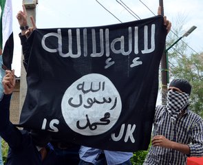 File - Protesters hold up a flag of the Islamic State of Iraq and the Levant (ISIL), shouting slogans during a protest against Israeli military operations in Gaza, in downtown Srinagar, India, July 18, 2014.