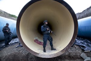 Federal police guard a drainage pipe outside of the Altiplano maximum security prison in Almoloya, west of Mexico City, Sunday, July 12, 2015.