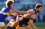 MELBOURNE, AUSTRALIA - JULY 17:  Kade Simpson of the Blues is tackled by Mitchell Brown and Mark LeCras of the Eagles  ...