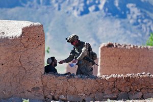 A paratrooper with the 82nd Airborne Division’s 1st Brigade Combat Team swaps an Afghan villager’s mouth for a DNA sample June 2, 2012, Ghazni Province, Afghanistan.  Paratroopers are searching his village, a suspected Taliban safe haven, for information and weapons caches.  (U.S. Army photo by Sgt. Michael J. MacLeod)