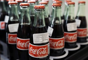 Bottles of Coca-Cola are on display at a Haverhill, Mass., supermarket. On Wednesday, April 20, 2016, Coca-Cola Co.