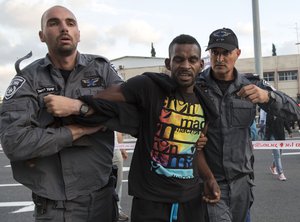 File - Israeli police officers detains an Israeli Ethiopian during a demonstration in Tel Aviv, Sunday, May 3, 2015.  Israel's Jewish Ethiopian minority were protesting against racism and police brutality.