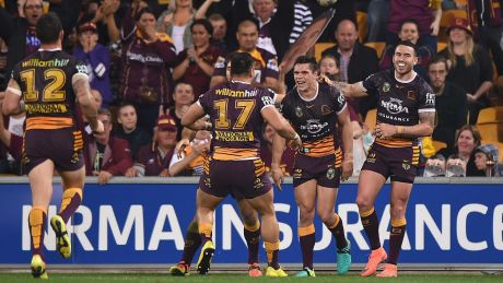 James Roberts of the Broncos celebrates scoring a try against the Roosters at Suncorp Stadium on Thursday night.