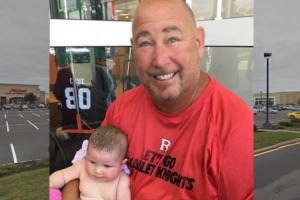 Steve Eckel with the baby he and a stranger saved from a hot car. 
