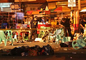 Philippine police officers look at dead victims after an explosion at a night market that has left about 10 people dead and wounded several others in southern Davao city, Philippines late Friday Sept. 2, 2016.