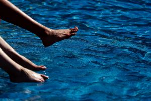 People enjoy the water in a pool during a hot and sunny day in central London.