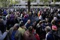 Hundreds of migrants and refugees wait for Berlin's State Office of Health and Welfare in Berlin, Germany, last year.