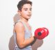 Boy Lifting Weight.Photographed in the studio, background white.