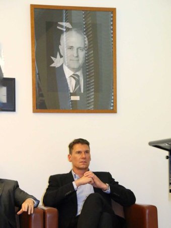 Cory Bernadi under a portrait of Malcolm Turnbull