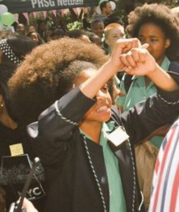 Schoolgirls protest school hair rules that they claim are discriminatory against black students. 