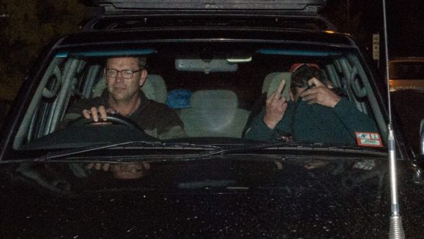 Mark Tromp, pictured right, is driven from the Wangaratta police station on Saturday night.