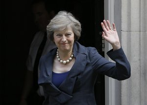 Britain's Home Secretary Theresa May waves towards the media as she arrives to attend a cabinet meeting at 10 Downing Street, in London, Tuesday, July 12, 2016.