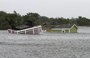 Two trailers sit overturned in the creek behind the Hatteras Sands Campground in Hatteras, North Carolina, Saturday, Sept. 3, 2016 after Tropical Storm Hermine passed the Outer Banks.