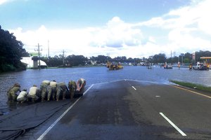 Soldiers provide support to the Louisiana Department of Transportation and Development by emplacing an aqua dam to divert water off of Highway 61 after flooding in Baton Rouge, Louisiana, Aug. 16, 2016.